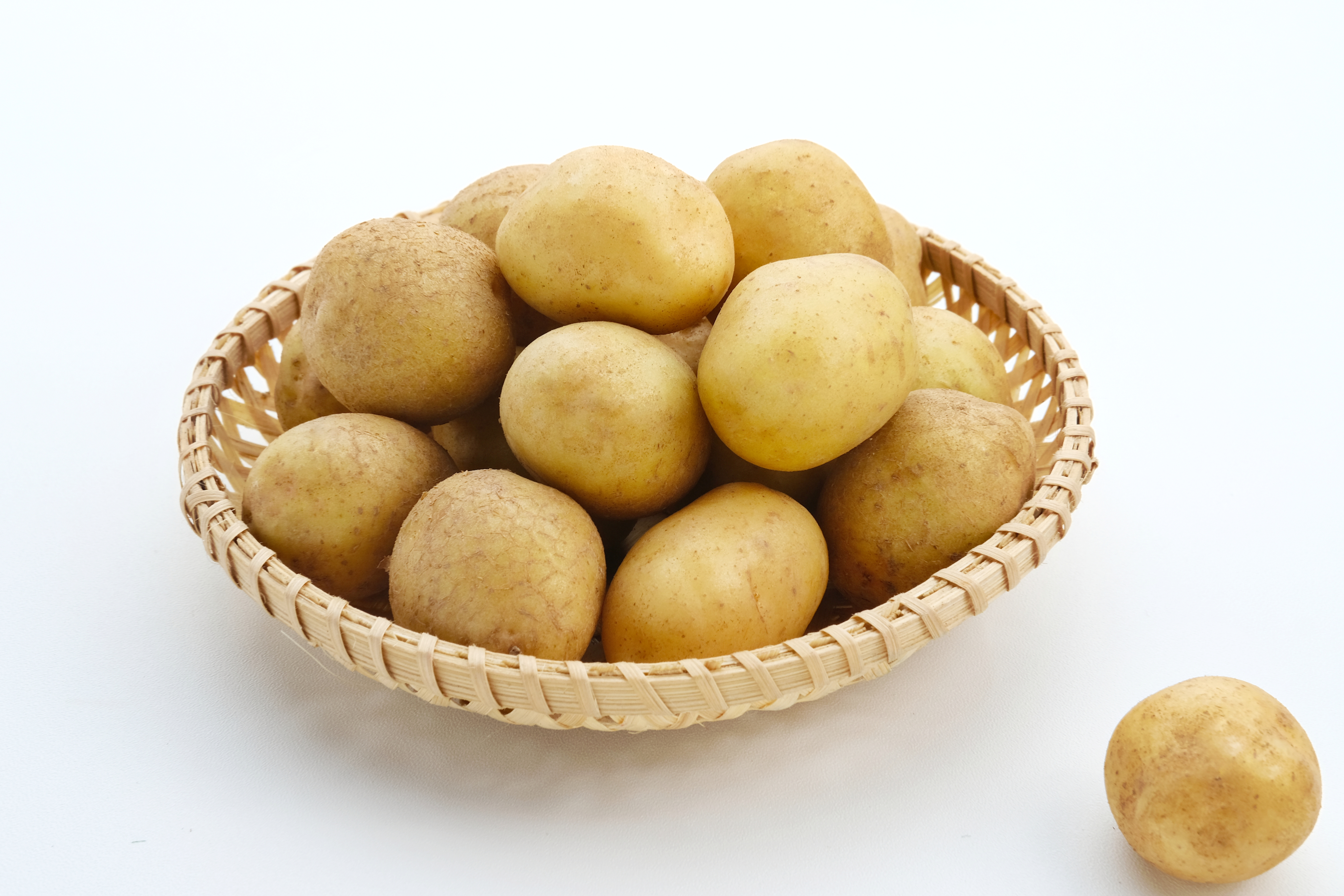 A pear set on a yellow plate upon a soft white canvas texture.